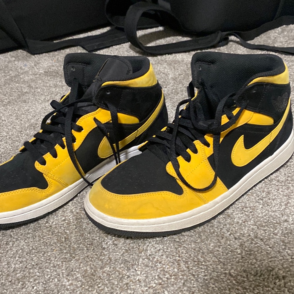 Yellow and black Jordan 1 mids